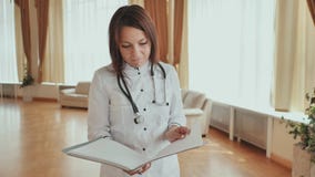 Girl doctor walking in hospital with documents stock footage Girl doctor walking in hospital with documents stock footage