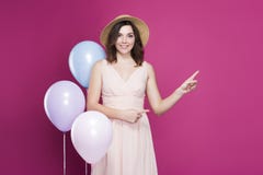 Girl in a dress and a straw hat on a pink background royalty free stock photos Girl in a dress and a straw hat on a pink background royalty free stock photos