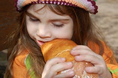 Girl Eating Bread Stock Images