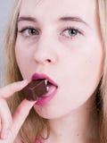 Girl Eating Chocolate Stock Photos