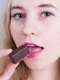 Girl Eating Chocolate Stock Photo