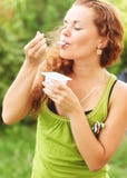 Girl Eats Yogurt And Has Closed Eye From Pleasure Royalty Free Stock Photo