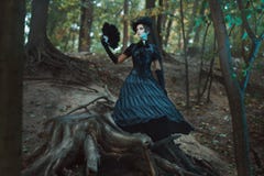 Girl in gothic dress standing among the snags forest. royalty free stock images Girl in gothic dress standing among the snags forest. royalty free stock images
