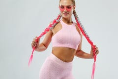 Fitenss athlete woman in a beautiful pink sportswear and pink glasses, on white background. Sport concept. royalty free stock photo Fitenss athlete woman in a beautiful pink sportswear and pink glasses, on white background. Sport concept. royalty free stock photo