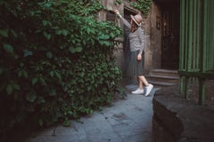 The girl in the hat opens a mailbox with sheets at the background of the old house stock photography The girl in the hat opens a mailbox with sheets at the background of the old house stock photography