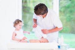 Girl helping her father to choose outfit for her brother stock images Girl helping her father to choose outfit for her brother stock images