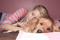 Girl and her dog sleeping together on a bedroom Stock Photos Girl and her dog sleeping together on a bedroom Stock Photos