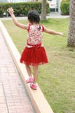 Girl with her doll in a garden stock photo Girl with her doll in a garden stock photo