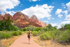 Girl on hiking trip in the red mountains, walking on pathway. stock photo Girl on hiking trip in the red mountains, walking on pathway. stock photo