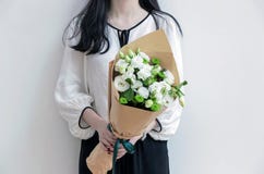 Girl holding white flower bouquet. Girl holding fresh white flower bouquet Royalty Free Stock Photography Girl holding white flower bouquet. Girl holding fresh white flower bouquet Royalty Free Stock Photography