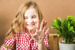 The girl is holding the ground. The girl will transplant potted plants at home. Earth, seedling, Spring, hands, the concept of pro stock image The girl is holding the ground. The girl will transplant potted plants at home. Earth, seedling, Spring, hands, the concept of pro stock image