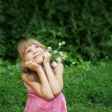 The girl ia sitting in the grass and dreaming stock photos The girl ia sitting in the grass and dreaming stock photos