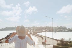 Girl In A Hat Looks At The Panorama Of The Old Town In Bulgaria. Woman And Road To Nesebar City Stock Image