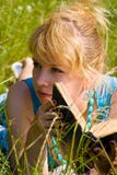 Girl In Grass With Book Stock Photography