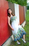 Girl In Light Dress Against Metal Fence Stock Photo Girl In Light Dress Against Metal Fence Stock Photo
