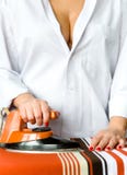 A girl ironing clothes with an old iron. royalty free stock photos A girl ironing clothes with an old iron. royalty free stock photos