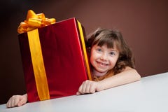 Girl joyously embraces the present Stock Photography Girl joyously embraces the present Stock Photography