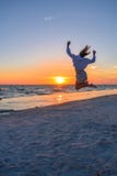 Girl Jumping On the Beach at Sunset