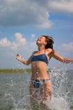 Girl Jumping In Water With Splashes Royalty Free Stock Photography