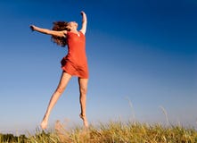 Girl Jumping On A Dune-1 Stock Images Girl Jumping On A Dune-1 Stock Images