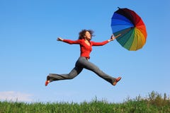 Girl jumping over grass with colorful umbrella royalty free stock photo Girl jumping over grass with colorful umbrella royalty free stock photo