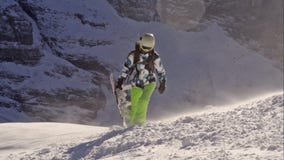 Girl jumping on a snowboard.Switzerland
