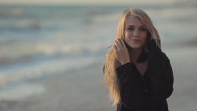 Girl with long blond hair walking along the