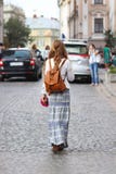 A girl with long, loose hair walks in beautiful hippie style clothes along the ancient streets of a medieval city. Young tourist royalty free stock image A girl with long, loose hair walks in beautiful hippie style clothes along the ancient streets of a medieval city. Young tourist royalty free stock image