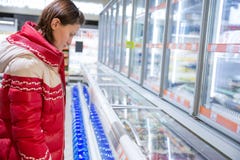 Girl makes a purchase at the grocery hypermarket royalty free stock images Girl makes a purchase at the grocery hypermarket royalty free stock images