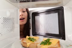 Girl Open A Microwave Royalty Free Stock Photos