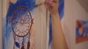 Girl painting a picture in home studio. Model woman painting her picture. Art. Woman draws paints Dreamcatcher. stock footage Girl painting a picture in home studio. Model woman painting her picture. Art. Woman draws paints Dreamcatcher. stock footage
