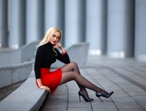 Girl with perfect legs in pantyhose at the city square.