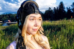 Girl pilot in a flight helmet is in the summer on a background of green grass in Sunny day royalty free stock images Girl pilot in a flight helmet is in the summer on a background of green grass in Sunny day royalty free stock images