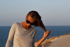 Girl playing with hair on beach Stock Photos Girl playing with hair on beach Stock Photos