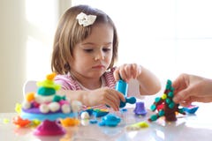 Girl playing with play dough Royalty Free Stock Photography Girl playing with play dough Royalty Free Stock Photography