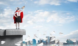Girl power concept with kid wearing cape and mask and playing trumpet. Mixed media royalty free stock photo Girl power concept with kid wearing cape and mask and playing trumpet. Mixed media royalty free stock photo