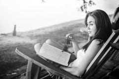 Girl reading book outdoor on the beach stock image Girl reading book outdoor on the beach stock image