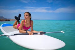 Girl relaxed lying on paddle surf board SUP royalty free stock photo Girl relaxed lying on paddle surf board SUP royalty free stock photo