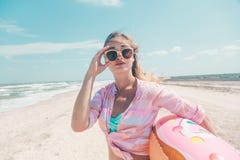 Girl relaxing on donut lilo on the beach stock images Girl relaxing on donut lilo on the beach stock images