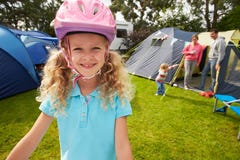 Girl Riding Scooter Whilst On Family Camping Holiday stock images Girl Riding Scooter Whilst On Family Camping Holiday stock images