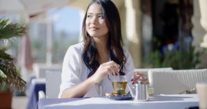 Girl Sitting At Cafe With Cup Of Tea