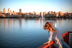 The girl is sitting on the railing of the bridge royalty free stock photos The girl is sitting on the railing of the bridge royalty free stock photos