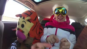 Girl skier having fun with the music in the car on the trip