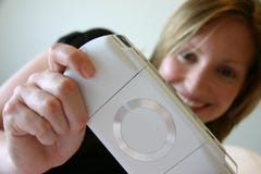 Girl Smiling And Playing Handheld Game Console Stock Images Girl Smiling And Playing Handheld Game Console Stock Images