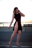 The girl is standing on a bridge in a black dress royalty free stock images The girl is standing on a bridge in a black dress royalty free stock images