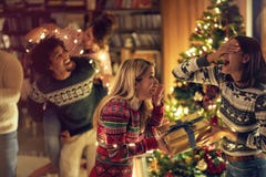 Girl surprising her friend girl with a romantic present at Christmas. Concept of celebration Christmas and new year royalty free stock images Girl surprising her friend girl with a romantic present at Christmas. Concept of celebration Christmas and new year royalty free stock images