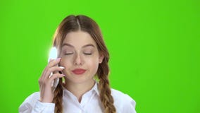 Girl is talking on the phone . Green screen stock footage Girl is talking on the phone . Green screen stock footage
