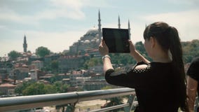 Girl tourist photographs on the gadget, beautiful view of the historical sights of the city stock video footage Girl tourist photographs on the gadget, beautiful view of the historical sights of the city stock video footage