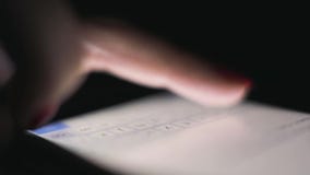 A girl uses the phone in the dark before going to bed. concept of: technology, safety, applications and games. close up stock footage A girl uses the phone in the dark before going to bed. concept of: technology, safety, applications and games. close up stock footage