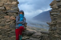 A girl on the walls of a ruined ancient fortress at the valley of the Pyandzh River on the border with Afghanistan